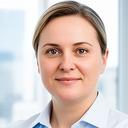 Professional portrait of a business owner in a bright office wearing a navy jacket and white shirt